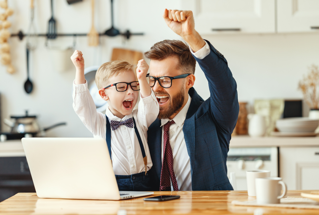 dad and son celebrating sales at laptop with kids venture box